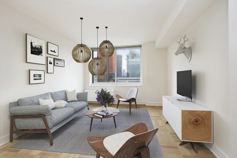 a living room with a gray couch and a tv